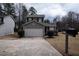 Two-story home featuring gray siding, a two-car garage, and well-maintained landscaping at 3934 Conley Downs Ln, Decatur, GA 30034