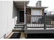Cozy front porch with gray railings, a black front door, and a welcoming mat at 3934 Conley Downs Ln, Decatur, GA 30034