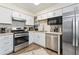 Bright kitchen with white cabinetry, stainless steel appliances, and stylish backsplash at 3934 Conley Downs Ln, Decatur, GA 30034