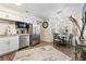 Eat-in kitchen with white cabinets, stainless steel appliances, and modern pendant lighting at 3934 Conley Downs Ln, Decatur, GA 30034