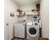 Efficient laundry room featuring modern washer and dryer with convenient shelving at 3934 Conley Downs Ln, Decatur, GA 30034