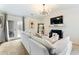 Bright living room with a white sofa, fireplace, and unique decor, including an artistic mirror at 3934 Conley Downs Ln, Decatur, GA 30034