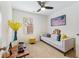 Bright office space featuring a cozy sofa, stylish decor, and a ceiling fan for added comfort at 3934 Conley Downs Ln, Decatur, GA 30034