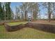 Large backyard features a built-in playground and a terraced stone retaining wall, offering ample space at 1072 Powell Wright Rd, Marietta, GA 30066