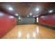 Finished basement with wood-look floors, recessed lighting, and wood-paneling at 1072 Powell Wright Rd, Marietta, GA 30066