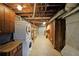 Unfinished basement with laundry area, utility shelving, and exposed ductwork at 1072 Powell Wright Rd, Marietta, GA 30066