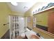 Cozy bathroom with wood accents, a shower-tub combination, and unique wall coverings at 1072 Powell Wright Rd, Marietta, GA 30066