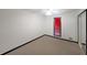 Simple bedroom with neutral carpet, closet, and a window with black trim at 1072 Powell Wright Rd, Marietta, GA 30066