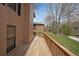 Long wooden deck featuring wood railings, a door to the main house, and a green lawn at 1072 Powell Wright Rd, Marietta, GA 30066