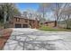 Property showcasing a neat lawn, a two-car garage, an outbuilding, and mature trees at 1072 Powell Wright Rd, Marietta, GA 30066