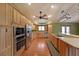 Well-equipped kitchen boasting stainless steel appliances, wood cabinets, and a spacious layout at 1072 Powell Wright Rd, Marietta, GA 30066