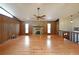 Bright living room featuring a stone fireplace, wood paneling, and a large window for natural light at 1072 Powell Wright Rd, Marietta, GA 30066