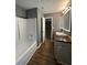 Bathroom with tub and shower featuring modern fixtures and a stylish vanity at 163 Woodwind Way, Jonesboro, GA 30238