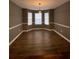 Elegant dining room featuring hardwood-style floors and large bay windows at 163 Woodwind Way, Jonesboro, GA 30238
