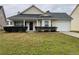Charming single-story home featuring manicured landscaping and an attached garage at 163 Woodwind Way, Jonesboro, GA 30238