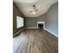 Spacious living room with vaulted ceiling, fireplace, and wood-look flooring at 163 Woodwind Way, Jonesboro, GA 30238