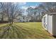 Expansive fenced backyard featuring green grass and a convenient storage shed at 55 Sunset Rd, Mcdonough, GA 30253