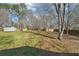 Beautiful backyard with mature trees, and a storage building at 55 Sunset Rd, Mcdonough, GA 30253