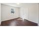 Well-lit bedroom with hardwood floors, a window, and a closet door at 55 Sunset Rd, Mcdonough, GA 30253