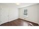 Bright bedroom features hardwood floors, fresh paint, and window overlooking outdoors at 55 Sunset Rd, Mcdonough, GA 30253