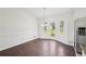 Bright dining room with wood floors, modern chandelier, and access to the backyard at 55 Sunset Rd, Mcdonough, GA 30253
