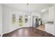 Bright dining room with wood floors, modern chandelier, and access to the backyard at 55 Sunset Rd, Mcdonough, GA 30253