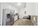 Well-lit kitchen with stainless steel appliances, tile backsplash, and granite countertops at 55 Sunset Rd, Mcdonough, GA 30253