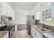 Bright kitchen with tile backsplash, granite countertops and stainless steel appliances at 55 Sunset Rd, Mcdonough, GA 30253