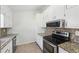 Bright kitchen featuring granite counters, stainless appliances and tile backsplash at 55 Sunset Rd, Mcdonough, GA 30253