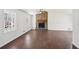 Open-concept living room featuring a cozy stone fireplace and hardwood floors at 55 Sunset Rd, Mcdonough, GA 30253