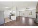 Open concept living room with fireplace, wood floors, neutral paint, and stainless steel appliances at 55 Sunset Rd, Mcdonough, GA 30253