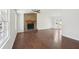 Open-concept living room featuring a cozy stone fireplace and hardwood floors at 55 Sunset Rd, Mcdonough, GA 30253