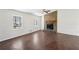 Open-concept living room featuring a cozy stone fireplace and hardwood floors at 55 Sunset Rd, Mcdonough, GA 30253