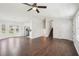 Open-concept living room and staircase featuring a cozy stone fireplace and hardwood floors at 55 Sunset Rd, Mcdonough, GA 30253