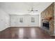Spacious living room featuring a cozy stone fireplace and hardwood floors at 55 Sunset Rd, Mcdonough, GA 30253