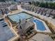 Community aerial view featuring townhomes, tennis courts, pool, and parking, highlighting amenities at 3318 Sardis Bend Dr, Buford, GA 30519