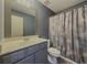 Charming bathroom with vanity, sink, modern mirror, a toilet and a shower curtain, exuding a comfortable style at 3318 Sardis Bend Dr, Buford, GA 30519