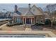 Clubhouse with brick and stone facade, arched windows, and manicured landscaping creating a welcoming space at 3318 Sardis Bend Dr, Buford, GA 30519