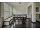 Inviting dining area with a large window, a stylish table, and dark hardwood flooring at 3318 Sardis Bend Dr, Buford, GA 30519