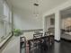 Bright dining room features a modern light fixture, a built-in bench, and dark hardwood floors at 3318 Sardis Bend Dr, Buford, GA 30519
