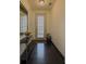 Bright hallway with dark wood floors, a decorative mirror, and a view of the front door at 3318 Sardis Bend Dr, Buford, GA 30519