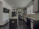 Modern kitchen with dark cabinets, stainless steel appliances, and granite countertops at 3318 Sardis Bend Dr, Buford, GA 30519