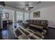 Open-concept living room with dark hardwood floors, a comfortable couch, and views of the dining area at 3318 Sardis Bend Dr, Buford, GA 30519