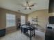 Inviting home office featuring neutral walls, carpet, ceiling fan, with two windows and a sleek black desk at 3318 Sardis Bend Dr, Buford, GA 30519