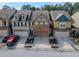 Charming townhomes feature attached garages and manicured front yards, enhancing the neighborhood's appeal at 3318 Sardis Bend Dr, Buford, GA 30519