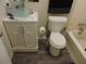 Bathroom boasts modern sink vanity with wood look flooring and a traditional toilet at 402 Pine Tree Trl, Atlanta, GA 30349