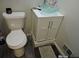 Updated bathroom features a modern sink vanity, new flooring, and traditional toilet at 402 Pine Tree Trl, Atlanta, GA 30349