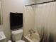 Bathroom with a toilet, tub and shower featuring neutral accents for a clean, functional space at 402 Pine Tree Trl, Atlanta, GA 30349
