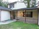 Charming front porch with dark trim, a white door and a small yard at 402 Pine Tree Trl, Atlanta, GA 30349