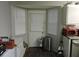 Kitchen features a bay window nook with backyard access and a view with an all-white palette at 402 Pine Tree Trl, Atlanta, GA 30349